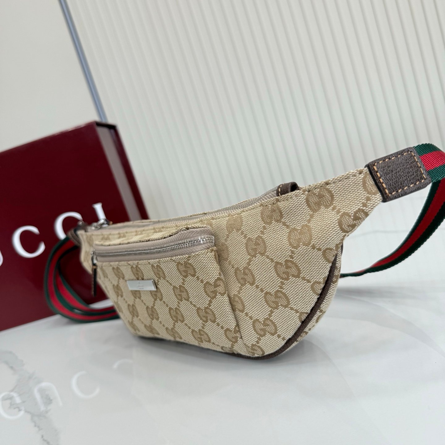 这件单品出自Gucci Primavera系列。Gucci Tag系列的设计同步城市节奏。经典GG帆布面料贯穿于多功能迷你手袋的廓形设计中，并缀饰“Gucci Made in Italy”金属标签，令整款单品更加精致。