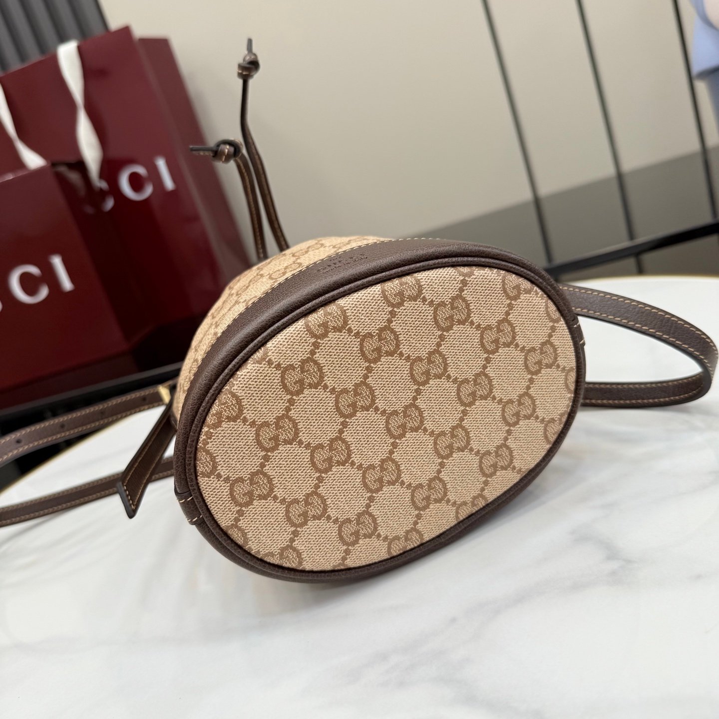 配全套原厂专柜包装 Generation Gucci古驰世代系列深入探索品牌的典藏元素，将不同世代的设计融合为统一的美学叙事。GG涂层帆布搭配经典织带，为多功能小型皮具带来标志性风格，如这款设计用于存放日常必需品的水桶包。